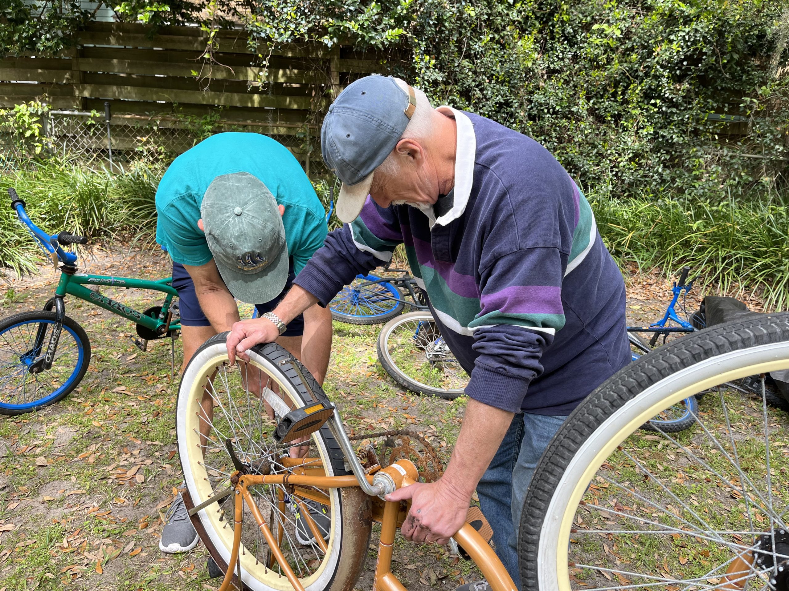 Two gentlemen restoring bikes